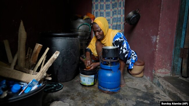 Idowu Bello, 56, prepares a meal in her kitchen in Ibadan, Nigeria, Friday, Sept. 13, 2024.