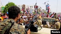 FILE - Members of UAE-backed southern Yemeni separatists forces are seen together with their supporters as they march during a rally in southern port city in Aden, Yemen August 15, 2019.