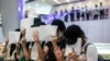 FILE - Protesters hold up blank papers during a demonstration in a mall in Hong Kong on July 6, 2020, in response to a national security law that makes political views, slogans, and signs advocating Hong Kong’s independence or liberation illegal. 