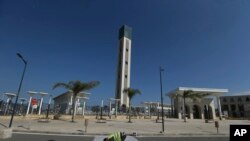 FILE — A worker paints the road outside the Djamaa El-Djazair, or Algiers Great Mosque, February 21, 2024 in Algiers.