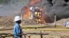 FILE - An oil well undergoes testing in the Lake Albertine region of western Uganda.