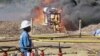 FILE- An oil well undergoes testing in the Lake Albertine region of western Uganda.