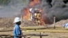 FILE- An oil well undergoes testing in the Lake Albertine region of western Uganda.