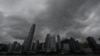 FILE - Heavy rain clouds are seen over Hong Kong on Oct. 8, 2023, as typhoon Koinu skirted by. The stock exchange will continue trading during heavy storms, the city's leader announced. 