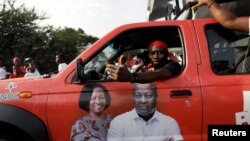 Supporter of the opposition National Democratic Congress drives a campaign vehicle ahead of the December 7th presidential and parliamentary elections in Accra, Ghana, Nov. 21, 2020.