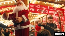 A vendor serves hot wine at the traditional Christkindelsmaerik (Christ Child market) near Strasbourg Cathedral. Nov. 24, 2012. 