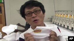 John Park, manager of the Astro Embroidery company in Port au Prince, Haiti