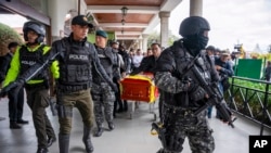 La policía escolta el ataúd del candidato presidencial asesinado Fernando Villavicencio a su llegada al cementerio Camposanto Monteolivo para su entierro en Quito, Ecuador, el viernes 11 de agosto de 2023. 