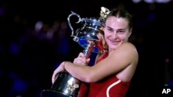 Aryna Sabalenka of Belarus holds the Daphne Akhurst Memorial Cup after defeating Zheng Qinwen of China in the women's singles final at the Australian Open tennis championships at Melbourne Park, Melbourne, on Jan. 27, 2024.