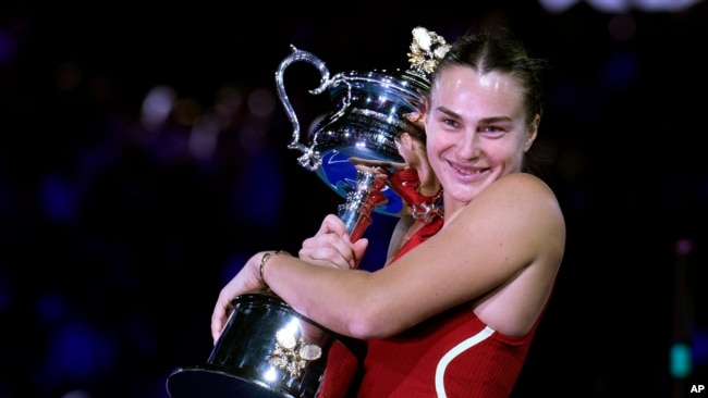 Aryna Sabalenka of Belarus holds the Daphne Akhurst Memorial Cup after defeating Zheng Qinwen of China in the women's singles final at the Australian Open tennis championships at Melbourne Park, Melbourne, on Jan. 27, 2024.
