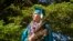 Dayne Hudson, a member of the Paiute Indian Tribe of Utah, walks with his eagle feather fan during the Canyon View High School graduation on May 22, 2022 in Cedar City, Utah. AP/Rick Bowmer