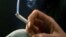 FILE - A woman smokes a cigarette. 