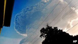 FILE - Ash rises into the air as the La Soufriere volcano erupts on the eastern Caribbean island of St. Vincent, April 13, 2021. 