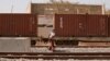 FILE - A woman walks along newly built tracks of the high-speed railway in Mbao, on the outskirts of Dakar, Senegal, Feb. 12, 2019. 