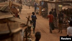 FILE - A boy walks in a camp sheltering internally displaced people next to the M'Poko international airport in Bangui, Central African Republic, Feb. 13, 2016.