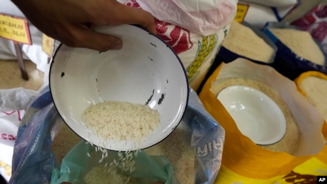 FILE - A worker prepares rice for sale in Bangkok, Thailand, on Aug. 10, 2023.