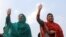 FILE - Kulsoom Nawaz (L), wife, and Maryam Nawaz (R), daughter former Pakistani prime minister Nawaz Sharif, wave to supporters at a campaign rally in Lahore, Pakistan, on May 4, 2013. Kulsoom Nawaz won her husband's parliamentary seat in a by-election Sunday.