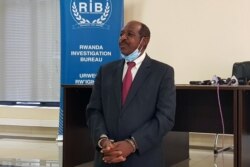 FILE - Paul Rusesabagina, the man who was hailed a hero in a Hollywood movie about Rwanda's 1994 genocide is paraded in handcuffs in front of media at the headquarters of Rwanda's Investigation Bureau, in Kigali, Aug. 31, 2020.