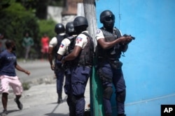 Police officers patrol in search for suspects in the murder Haiti's President Jovenel Moise, in Port-au-Prince, Haiti, July 8, 2021.