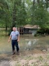 Miguel Flores Sr. stands in his flooded backyard outside his home in the northeast Houston neighborhood of Kingwood on May 4, 2024. Officials said the area had about four months' worth of rain in about a week’s time.