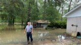 Miguel Flores Sr. stands in his flooded backyard outside his home in the northeast Houston neighborhood of Kingwood on May 4, 2024. Officials said the area had about four months' worth of rain in about a week’s time.