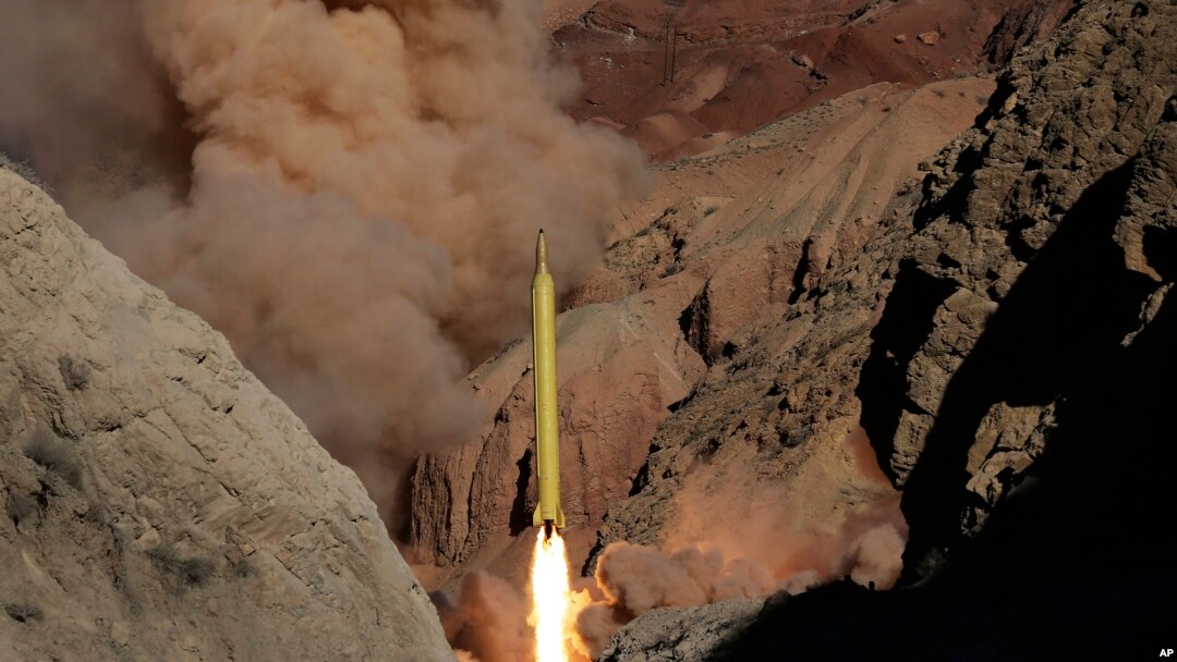 In this photo obtained from the Iranian Fars News Agency, a Qadr H long-range ballistic surface-to-surface missile is fired by Iran's Revolutionary Guard, during a maneuver, in an undisclosed location in Iran, Wednesday, March 9, 2016.