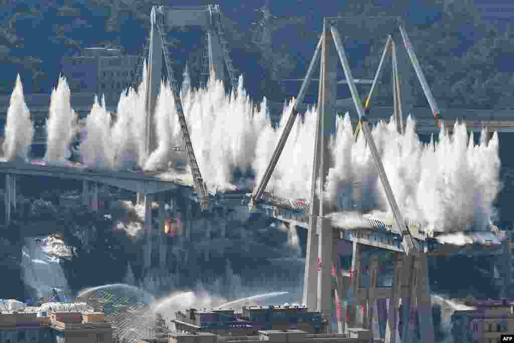 Explosive charges blow up the eastern pylons of Genoa&#39;s Morandi motorway bridge in Genoa, Italy.