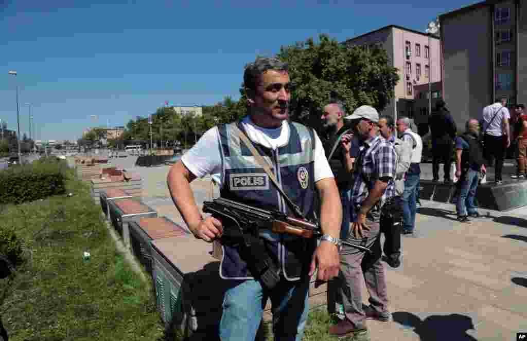 A police officer stands outside Turkey's parliament near the Turkish military headquarters in Ankara, Turkey, July 16, 2016. Forces loyal to Turkey's President Recep Tayyip Erdogan quashed a coup attempt in a night of explosions, air battles and gunfire t