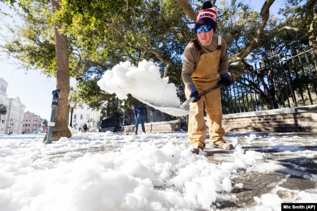 Dylan Gilbert, with the City of Charleston, removes snow in front of City Hall after a winter storm dropped ice and snow Wednesday, Jan. 22, 2025, on Charleston, S.C.