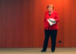 German Chancellor Angela Merkel waits for the beginning of a press conference in Berlin, Germany, May 6, 2020.