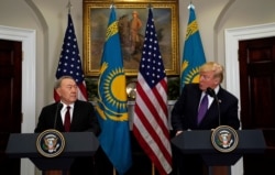 FILE - U.S. President Donald Trump and Kazakhstan President Nursultan Nazarbayev shake hands in the Roosevelt Room of the White House in Washington, Jan. 16, 2018.