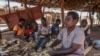 FILE - Women shell maize in the Malembo Village in the Traditional Authority (TA) Khongoni in Lilongwe District, Malawi, May 16, 2019,