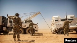 FILE — Members of the MINUSMA Guinean contingent pull their stranded escort vehicle during a logistic convoy from Gao to Kidal, Mali February 17, 2017.