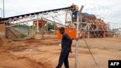 FILE - A security employee guards a diamond-processing plant in the diamond-rich eastern Marange region of Zimbabwe, Dec. 14, 2011 