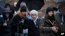 Holocaust survivors and relatives arrive at the Auschwitz Nazi death camp in Oswiecim, Poland, on Jan. 27, 2024. Survivors of Nazi death camps marked the 79th anniversary of the liberation of the Auschwitz-Birkenau camp during World War II in a modest ceremony in southern Poland.