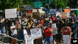 Protesters gather outside of the Queens County Criminal Court, June 8, 2020, in the Queens borough of New York. New York lawmakers are debating police reform bills as protesters demand accountability.