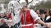 Men throw water on a woman as part of traditional Easter celebrations in Szenna, Hungary, March 28, 2016. 