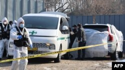 Police investigate a car in which the body of South Korean actor Lee Sun-kyun was found at a park in central Seoul on Dec. 27, 2023.