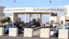 Police officers and security forces stand guard outside a police training center east of Amman, Nov. 9, 2015, where a Jordanian officer shot dead two U.S. soldiers and wounded two other Americans before killing himself. 