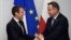 FILE - FILE - French President Emmanuel Macron (L) and Polish President Andrzej Duda shake hands during their bilateral meeting on the sidelines of the NATO (North Atlantic Treaty Organization) summit in Brussels, on May 25, 2017.