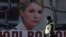 An Interior Ministry officer walks past a board displaying a portrait of jailed former Ukrainian Prime Minister and opposition leader Yulia Tymoshenko at a protest tent camp set up by her supporters in central Kyiv, Nov. 18, 2013.