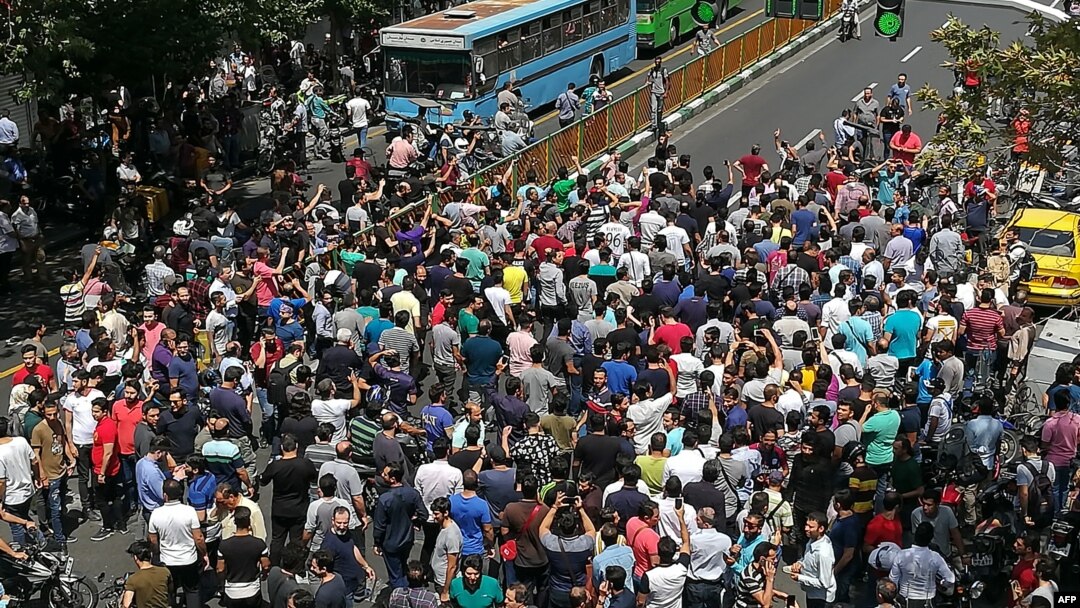 FILE - Iranian protesters shout slogans during a demonstration in central Tehran, June 25, 2018.