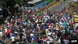 FILE - Iranian protesters shout slogans during a demonstration in central Tehran, June 25, 2018.