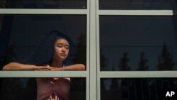 FILE - Marina Aina, a 21-year-old American Studies major at Pomona College, poses for photos on the school's campus in Claremont, Calif., Sept. 22, 2022. Aina was used to getting paid for her internships and could not see taking an unpaid opportunity over a summer job. 