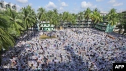 Followers of Allama Shah Ahmad Shafi, who had led the hardline Hefazat-e-Islam group, offer his funeral prayers, in Chittagong on Sept. 19, 2020.