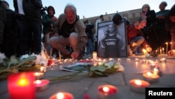 People take part in a candle-light vigil in memory of Bulgarian TV journalist Viktoria Marinova in Sofia, Bulgaria, Oct. 8, 2018. 