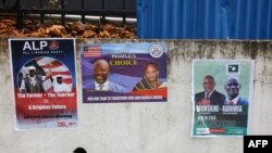 Picture taken July 31, 2017 in Monrovia shows campaign posters on a wall as the campaign kicks off for the presidency and House of Representatives elections in October.