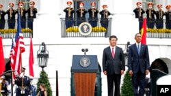 President Barack Obama and Chinese President Xi Jinping stand at attention for the playing of each counties national anthem during an official state arrival ceremony for the Chinese president, Sept. 25, 2015.