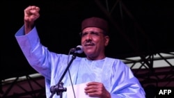 FILE - Niger's newly elected president Mohamed Bazoum gestures as he delivers a speech at his party headquarters, in Niamey, Feb. 23, 2021.