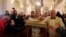 The Latin Patriarch of Jerusalem Fouad Twal (2nd R) carries a statuette of baby Jesus during Christmas midnight mass at the Church of St. Catherine, which is connected to the Church of the Nativity, in the West Bank town of Bethlehem. 